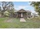 Charming stone-clad home featuring a brick walkway and covered front porch at 369 Bluff Lake Rd, Mascotte, FL 34753