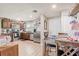 Inviting kitchen and dining area, featuring stainless steel appliances, wooden cabinetry, and laminate floors at 369 Bluff Lake Rd, Mascotte, FL 34753