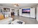 Spacious living room with neutral colors, modern entertainment center, and ample natural light at 369 Bluff Lake Rd, Mascotte, FL 34753