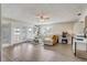 Bright living room featuring stylish floors, a white sectional sofa, and scenic lake views at 369 Bluff Lake Rd, Mascotte, FL 34753