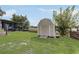 Exterior view of a shed that compliments the house with yard and lake views at 369 Bluff Lake Rd, Mascotte, FL 34753