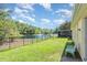 Fenced backyard features a serene lake view with a fountain, providing a peaceful outdoor space at 3896 Esplanade Ave, Port Orange, FL 32129