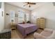 Bright bedroom featuring a ceiling fan, wood-look floors, three windows and a comfy chair at 3896 Esplanade Ave, Port Orange, FL 32129