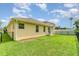 Exterior view of the home shows a well-manicured lawn and fenced yard at 3896 Esplanade Ave, Port Orange, FL 32129