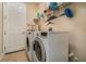 Laundry room featuring a washer, dryer, overhead storage shelves and a white door at 3896 Esplanade Ave, Port Orange, FL 32129
