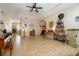Open-concept living room featuring hardwood floors, arches, ceiling fan, and natural light at 3896 Esplanade Ave, Port Orange, FL 32129