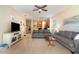 Open-concept living room with hardwood floors, ceiling fan, and view of kitchen and dining area at 3896 Esplanade Ave, Port Orange, FL 32129