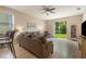 Cozy living room with a ceiling fan, natural light, and a sliding glass door to the backyard at 3896 Esplanade Ave, Port Orange, FL 32129