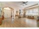 Spacious living area with hardwood floors, arches, neutral paint, and natural light at 3896 Esplanade Ave, Port Orange, FL 32129