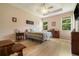 Light-filled main bedroom features hardwood floors, a tray ceiling, and two large windows at 3896 Esplanade Ave, Port Orange, FL 32129