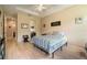 Main bedroom features hardwood floors, a ceiling fan, closet with mirrored doors, and private bathroom access at 3896 Esplanade Ave, Port Orange, FL 32129