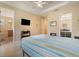 Main bedroom features hardwood floors, a ceiling fan, and access to the main bathroom at 3896 Esplanade Ave, Port Orange, FL 32129
