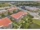 An aerial view of a residential community with multiple buildings, manicured landscaping, and nearby shopping at 4804 Cayview Ave # 20512, Orlando, FL 32819
