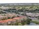 Aerial view of the condo community, commercial buildings, and roadways near a lake at 4804 Cayview Ave # 20512, Orlando, FL 32819