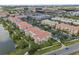Condo community featuring multiple buildings with terra cotta roofs, lake and roadways at 4804 Cayview Ave # 20512, Orlando, FL 32819