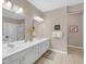 Bright bathroom featuring a dual sink vanity, soaking tub, and a glass-enclosed shower at 4804 Cayview Ave # 20512, Orlando, FL 32819