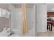 Bathroom featuring a tub/shower, white tile, and an entrance to the kitchen at 4804 Cayview Ave # 20512, Orlando, FL 32819