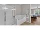Clean bathroom featuring a walk-in shower and a soaking tub near bedroom at 4804 Cayview Ave # 20512, Orlando, FL 32819