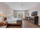 Spacious bedroom features a queen bed, large window, and dark dresser with a TV at 4804 Cayview Ave # 20512, Orlando, FL 32819