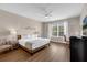 Spacious bedroom featuring a queen bed, a large window, a desk, and simple décor at 4804 Cayview Ave # 20512, Orlando, FL 32819