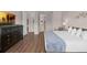 Warm bedroom featuring a queen bed, dark dresser, and access to the bathroom at 4804 Cayview Ave # 20512, Orlando, FL 32819