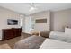 Cozy bedroom with two beds, dresser with TV, and neutral decor, ideal for relaxation and comfort at 4804 Cayview Ave # 20512, Orlando, FL 32819