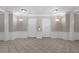 Hallway with access to elevators, featuring tile flooring and decorative wall lighting at 4804 Cayview Ave # 20512, Orlando, FL 32819