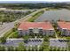 A beautiful apartment building with multiple floors, balconies, a red tile roof and a parking lot out front at 4804 Cayview Ave # 20512, Orlando, FL 32819