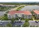 A beautiful apartment building with multiple floors, balconies, a red tile roof and a parking lot out front at 4804 Cayview Ave # 20512, Orlando, FL 32819