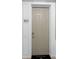 Unit 205 front door with a welcoming door mat, located in a hallway at 4804 Cayview Ave # 20512, Orlando, FL 32819