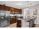 Modern kitchen with dark wood cabinets, stainless steel appliances, and a breakfast bar with seating at 4804 Cayview Ave # 20512, Orlando, FL 32819