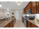 Well-equipped kitchen with granite countertops, stainless steel appliances, and warm wood cabinets at 4804 Cayview Ave # 20512, Orlando, FL 32819