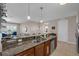 Gourmet kitchen featuring granite countertops, stainless appliances, and open layout to the living area at 4804 Cayview Ave # 20512, Orlando, FL 32819