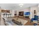Open-concept living space with hardwood floors, a comfortable sofa, TV and adjacent kitchen at 4804 Cayview Ave # 20512, Orlando, FL 32819