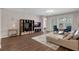 Well-lit living room with wood flooring, neutral walls, and a comfortable seating arrangement at 4804 Cayview Ave # 20512, Orlando, FL 32819