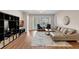 Bright living room with hardwood floors, a stylish couch, and large windows at 4804 Cayview Ave # 20512, Orlando, FL 32819