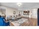 Inviting living room with hardwood floors, a comfortable sofa, and adjacent kitchen with breakfast bar at 4804 Cayview Ave # 20512, Orlando, FL 32819