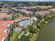 A resort-style pool and clubhouse in a multi-Gathering community next to a lake and other residences at 4804 Cayview Ave # 20512, Orlando, FL 32819