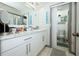 Bathroom with white cabinets, marble countertop and open shower at 5027 Vineland Rd # 5027, Orlando, FL 32811