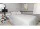 Bedroom with neutral walls, tile floors and a large window at 5027 Vineland Rd # 5027, Orlando, FL 32811