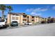 Attractive condo building featuring parking, landscaping, and direct access to various units at 5027 Vineland Rd # 5027, Orlando, FL 32811