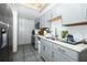 Well-lit kitchen featuring stainless steel appliances, light gray cabinets and a skylight at 5027 Vineland Rd # 5027, Orlando, FL 32811