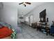 Open-concept living room with connecting dining area, TV, and lots of natural light at 5027 Vineland Rd # 5027, Orlando, FL 32811