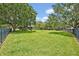 Sprawling backyard with lush green grass and mature trees, perfect for outdoor activities at 513 Legacy Park Dr, Casselberry, FL 32707