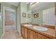 Bathroom featuring dual sinks, a large mirror, light green walls, and an adjacent room with a tub and toilet at 513 Legacy Park Dr, Casselberry, FL 32707