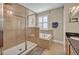 Bright bathroom featuring a tiled shower with glass door, separate tub under a window, and granite topped vanity at 513 Legacy Park Dr, Casselberry, FL 32707