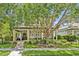 Charming two-story home featuring a covered front porch and lush landscaping at 513 Legacy Park Dr, Casselberry, FL 32707