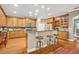 Spacious kitchen with modern appliances, wooden cabinetry, and a breakfast bar at 513 Legacy Park Dr, Casselberry, FL 32707