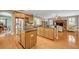 A well-appointed kitchen features light wood cabinets, stainless steel appliances, and a granite island and countertops at 513 Legacy Park Dr, Casselberry, FL 32707