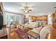 Inviting living room showcases hardwood floors, plantation shutters, and seamless transition to a spacious kitchen at 513 Legacy Park Dr, Casselberry, FL 32707